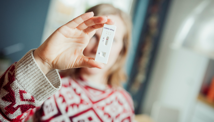 Woman holding a COVID-19 test