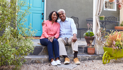 Couple sitting together on front porch steps