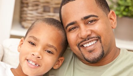 father and son smiling