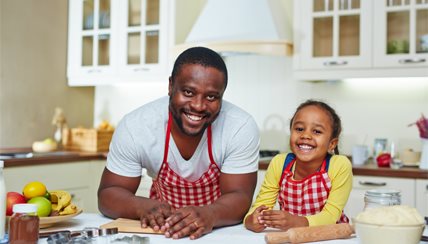 dad and daughter preparing food