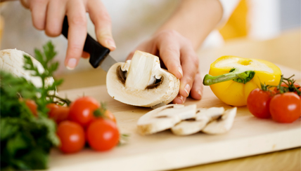 slicing veggies on a cutting board