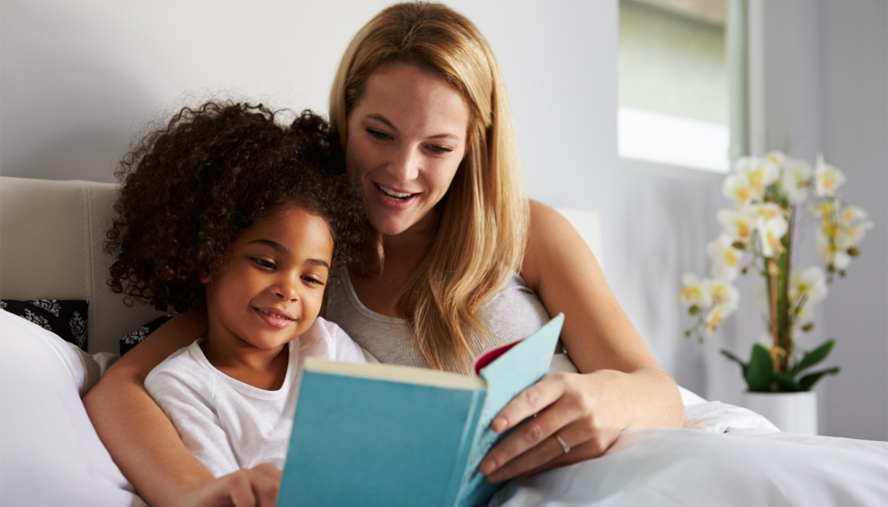 Mother and daughter reading before bed