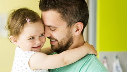 father holding toddler daughter