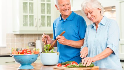 Older couple making a salad