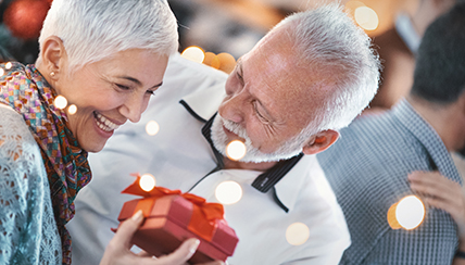 older couple exchanging gifts