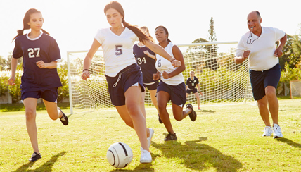 young women playing soccer