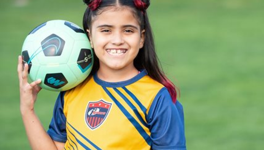 girl holding soccer ball