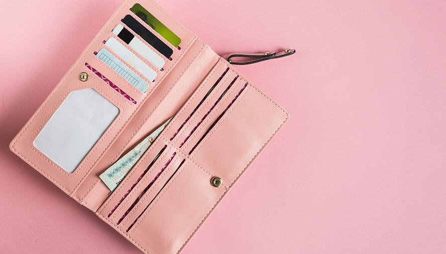 A pink wallet with many pockets