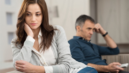 Man and woman both hands to head in frustration