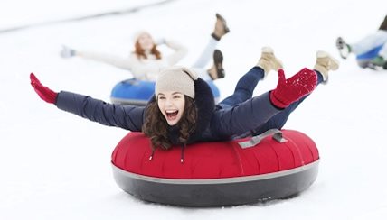 Women tubbing in the winter