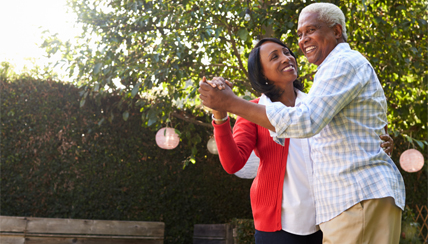 Two seniors dancing playfully