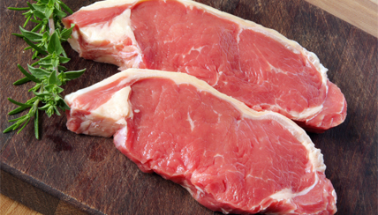 raw steak with rosemary sprig