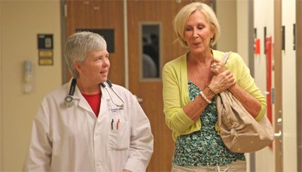 physician walking with a patient