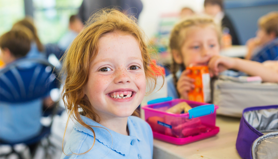 Happy child with lunchbox