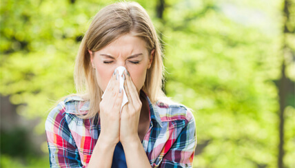 Woman blowing her nose