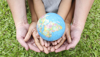 Hands holding a globe