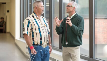 Man with COPD talking with their doctor