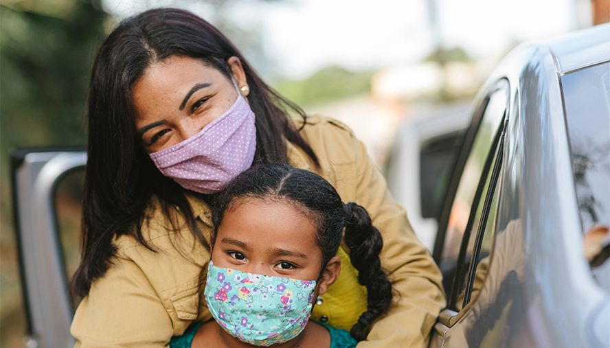 mother and daughter wearing masks