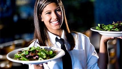 Waitress carrying salads