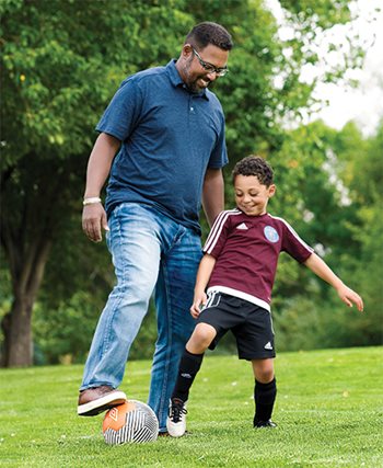 Remy Escal and father playing soccer