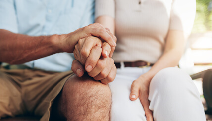 senior couple holding hands