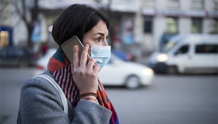 woman in city in mask