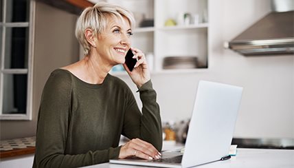 Social Distancing, Self-Isolation and Self-Quarantine: Woman sitting at her laptop