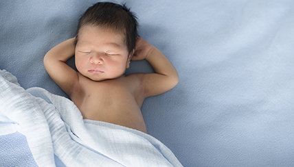 infant asleep on back