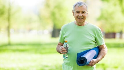 Senior man with yoga mat